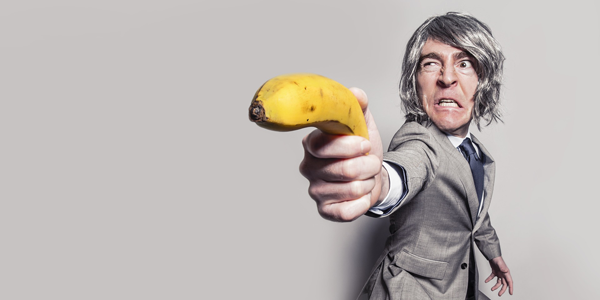 man holding a banana gun